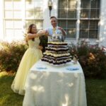 A new bride and groom cut their wedding cake.