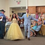 A wedding couple enters the reception.